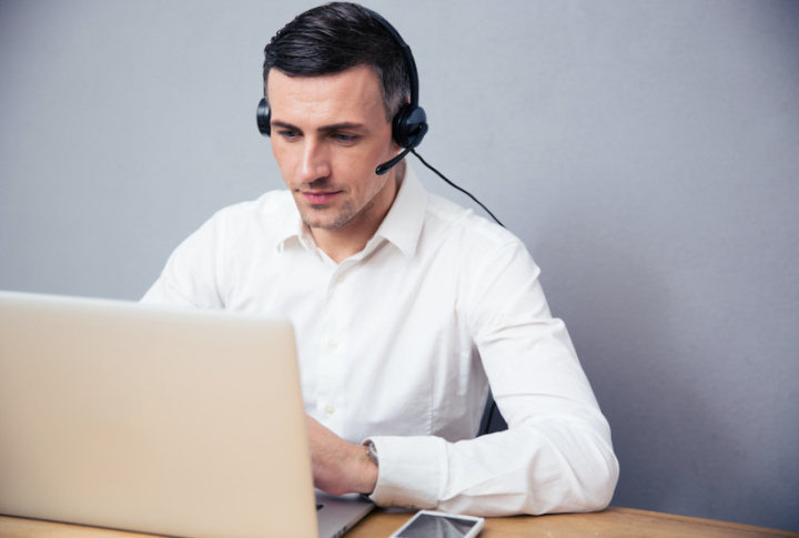 Photo of a man in front a computer